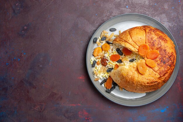 Top view of tasty shakh plov with raisins on dark surface