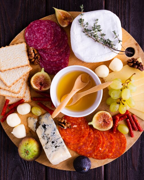 Top view tasty snacks on a wooden board