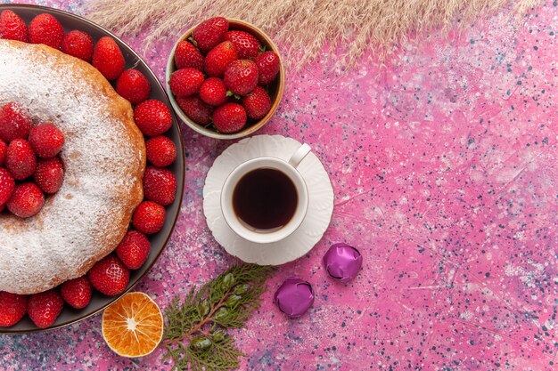 Top view tasty strawberry pie with sugar powder on a pink