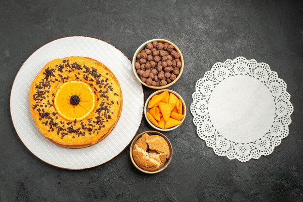 Top view tasty sweet pie with orange slices on a dark surface pie cake dessert tea sweet biscuit