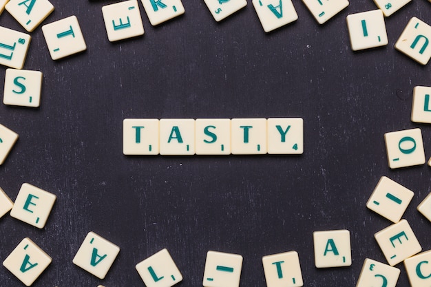 Free photo top view of tasty text made from scrabble game letters