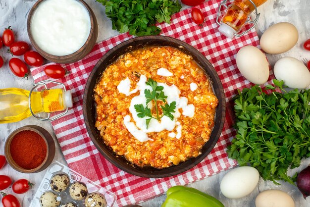 Top view tasty tomato omelette with greens and fresh vegetables on the white background morning breakfast bread milk lunch color