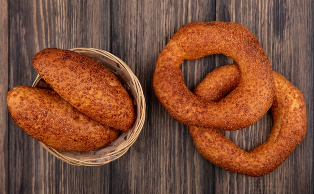 Top view of tasty turkish bagels with patties on a bucket on a wooden background