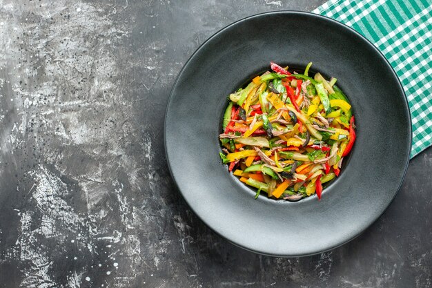 Top view of tasty vegetable salad on dark surface