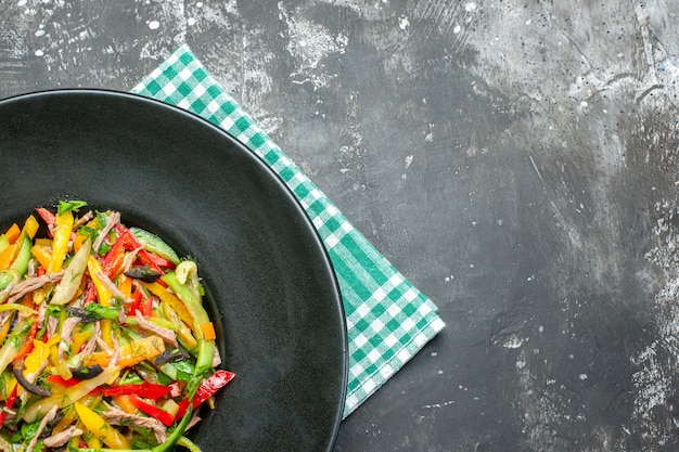 Top view of tasty vegetable salad on dark surface