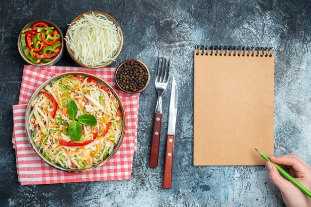 Top view of tasty vegetable salad on dark surface