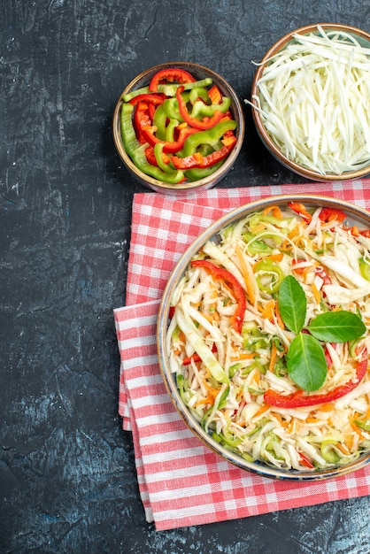 Top view of tasty vegetable salad on dark surface