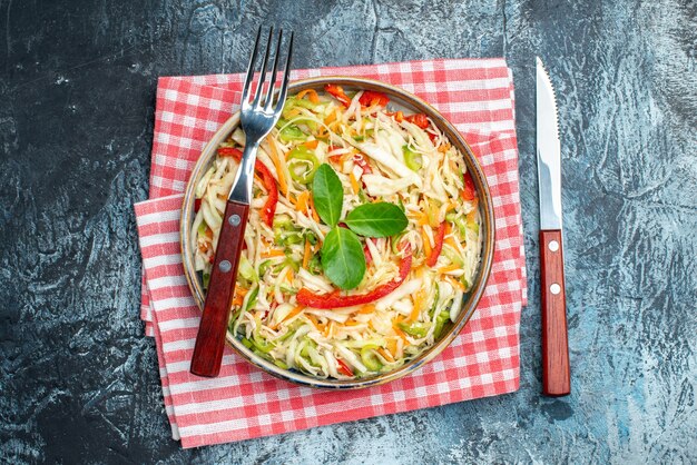 Top view of tasty vegetable salad on dark surface