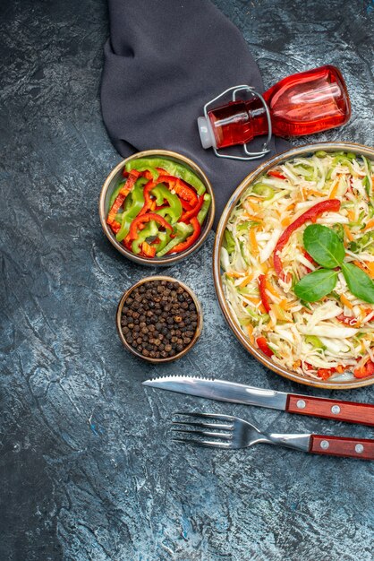 Top view of tasty vegetable salad on dark surface