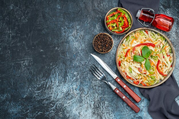 Top view of tasty vegetable salad on dark surface