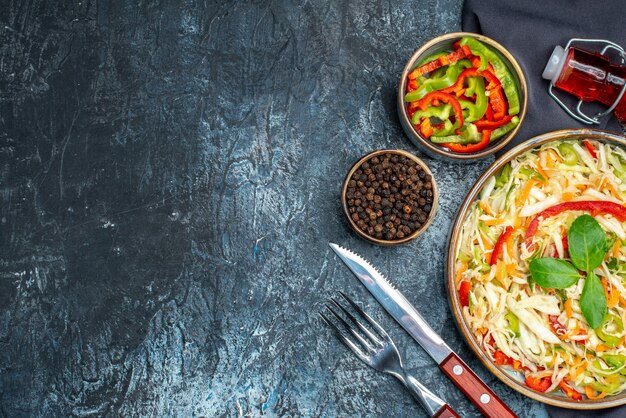 Top view of tasty vegetable salad on dark surface