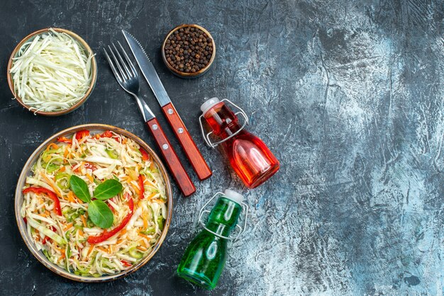 Top view of tasty vegetable salad on dark surface