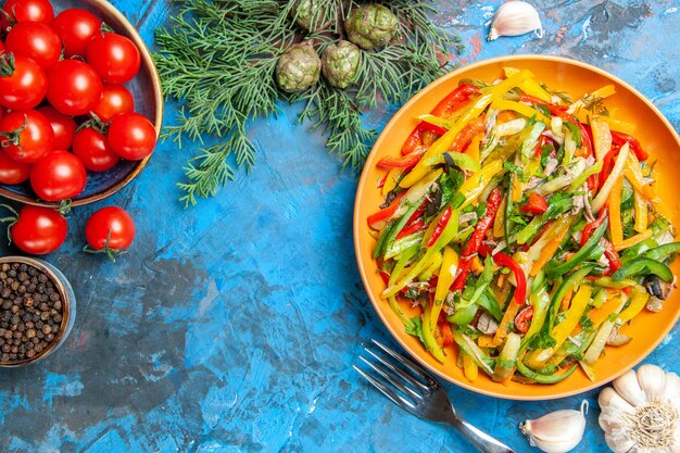 Top view of tasty vegetable salad on dark surface