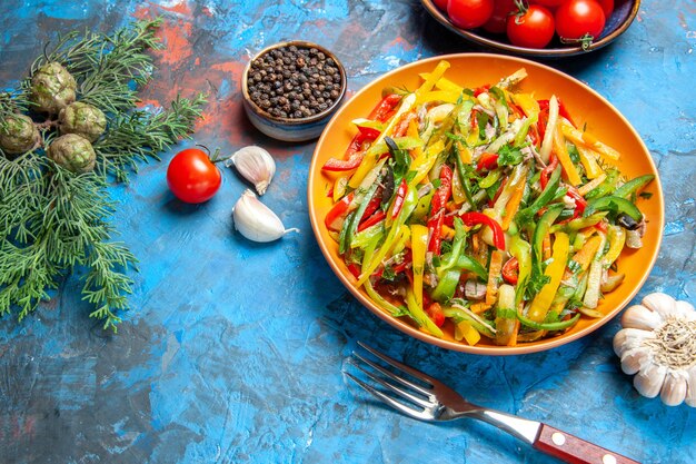 Top view of tasty vegetable salad on dark surface