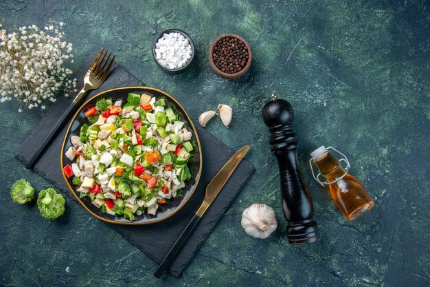 top view tasty vegetable salad inside plate on the dark-blue background cuisine restaurant fresh meal color health lunch food diet