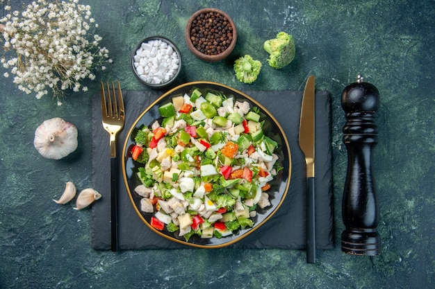 top view tasty vegetable salad inside plate with cutlery on dark background cuisine restaurant fresh meal color health lunch diet