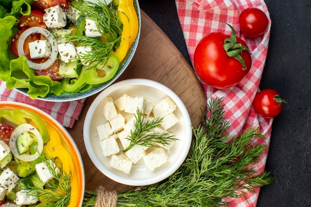 top view tasty vegetable salad with cheese and tomatoes on dark background