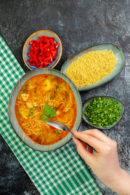 Top view tasty vermicelli soup with greens on light-grey table