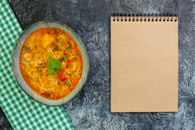 Top view tasty vermicelli soup with notepad on light-grey table