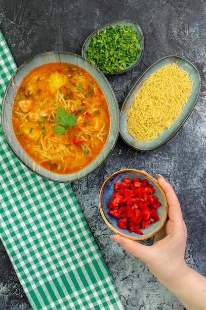 Top view tasty vermicelli soup with seasonings on light-grey table