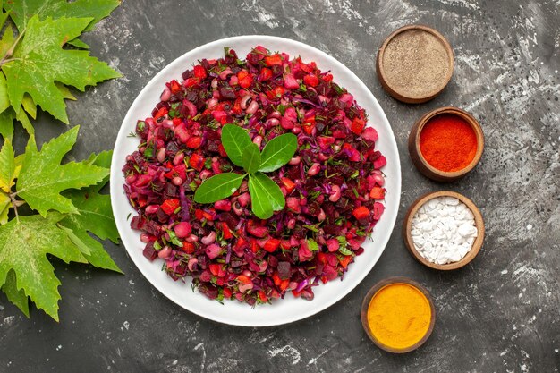 Top view tasty vinaigrette beet salad with seasonings on dark surface