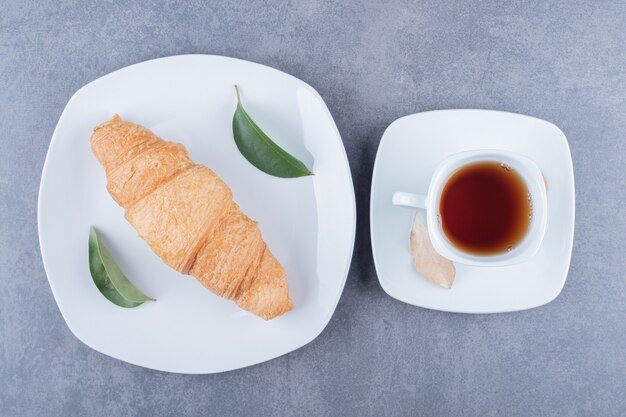 Top view of Tea and croissants. Classic breakfast.