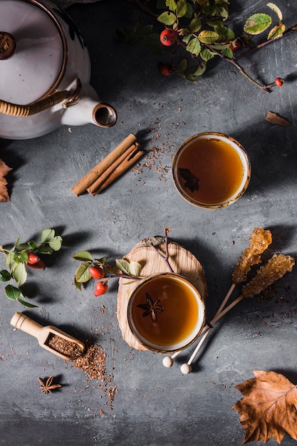 Top view tea in cup with crystallized sugar and cinnamon