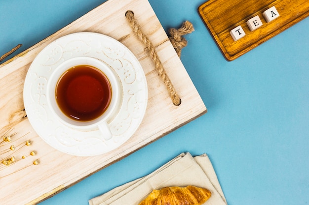 Free photo top view tea cup with letter dices and tablet