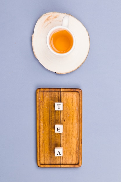 Free photo top view tea cup with letter dices