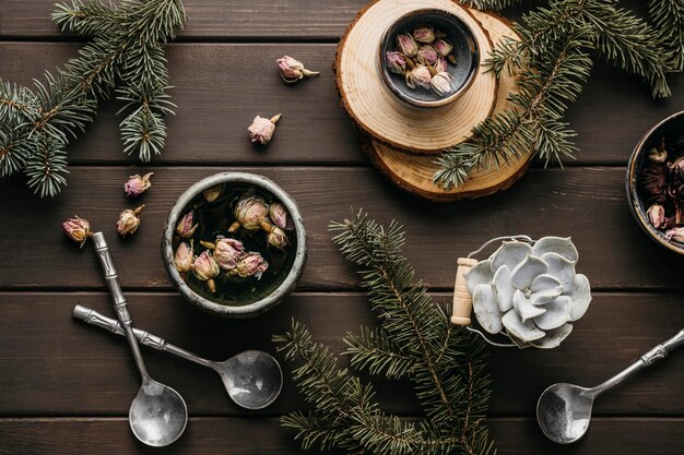 Free photo top view tea with dried flowers and pine branches