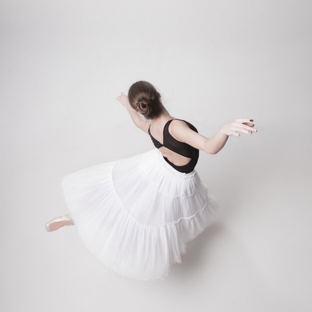 The top view of the teen ballerina on white background