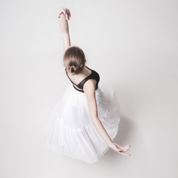 The top view of the teen ballerina on white studio