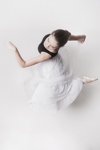 The top view of the teen ballerina on white