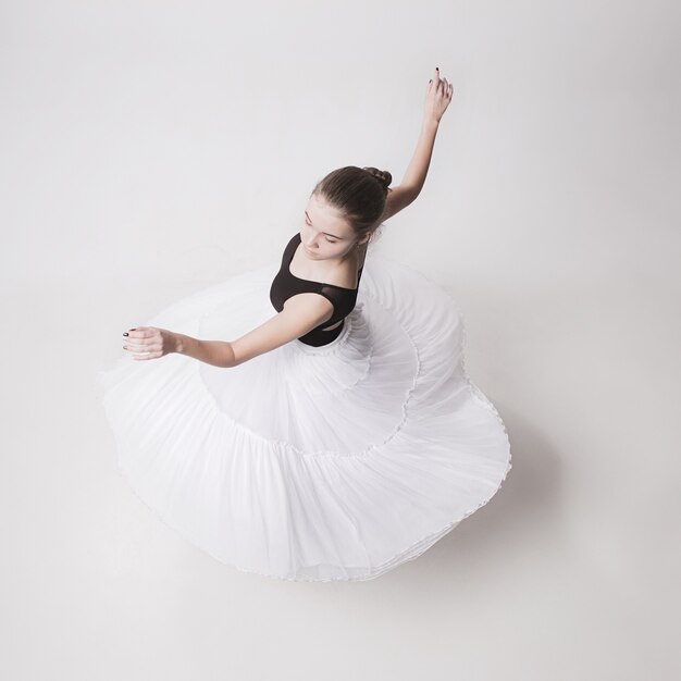 The top view of the teen ballerina on white