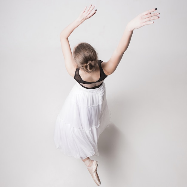 The top view of the teen ballerina on white