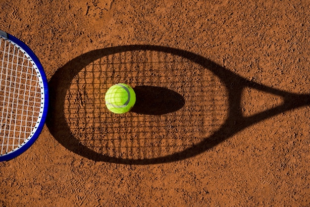 Top view tennis racket shadow with a ball