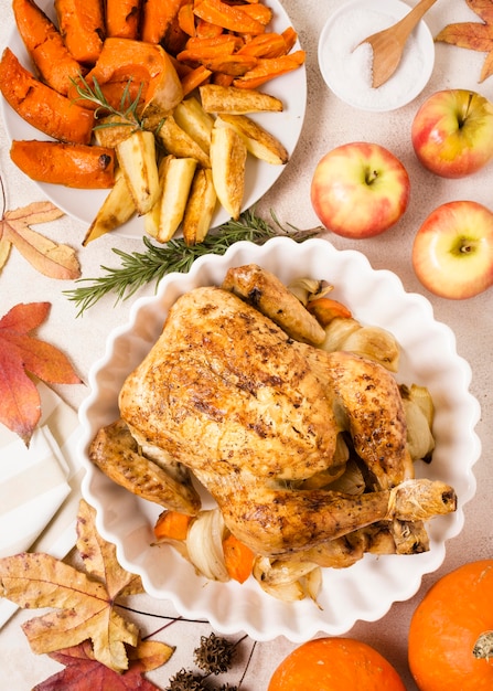 Top view of thanksgiving roasted chicken on plate with other dishes