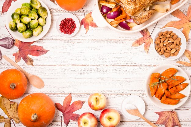 Top view of thanksgiving table with roasted chicken and copy space