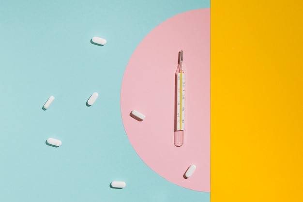 Top view thermometer with capsules on the table