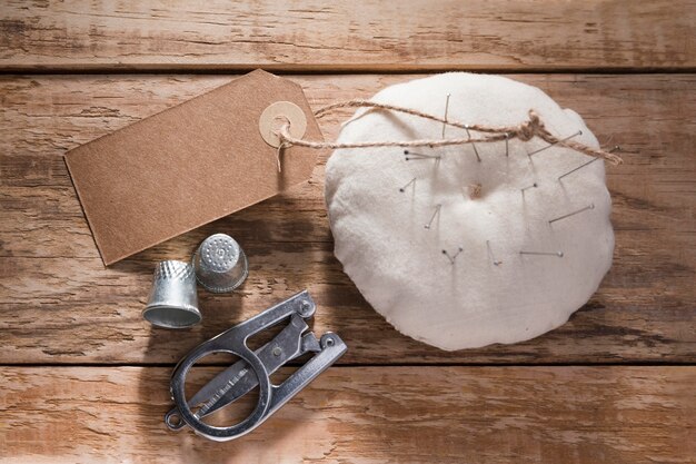 Top view of thimbles with sewing needles and scissors