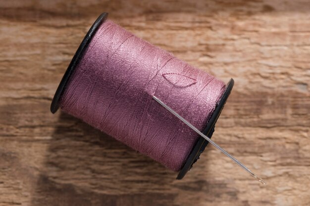 Top view of thread reel with sewing needle