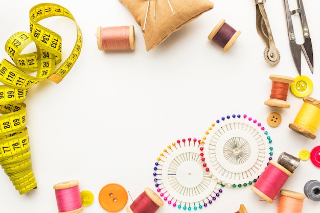 Top view of thread with needles and measuring tape