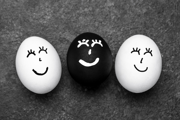 Top view of three different colored eggs with faces for black lives matter movement