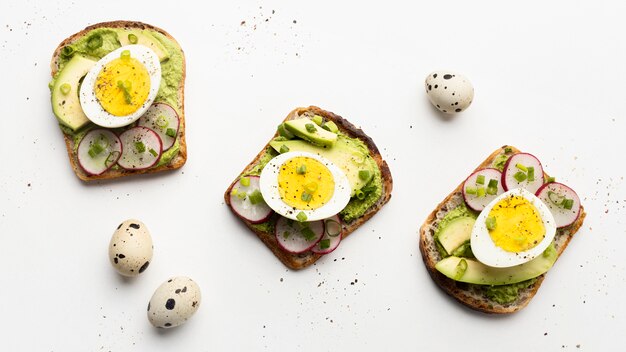 Top view of three egg and avocado sandwiches