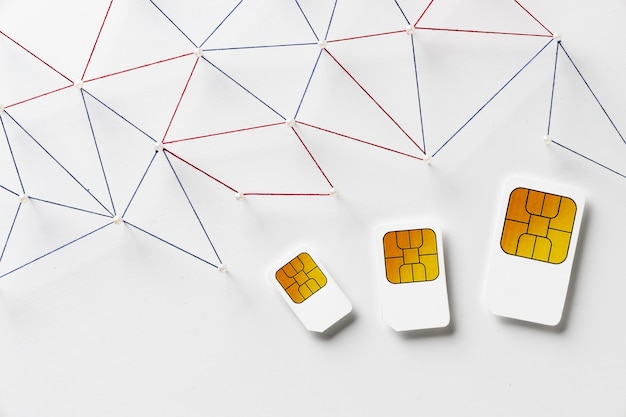 Top view of three sim cards with internet communication network Free Photo