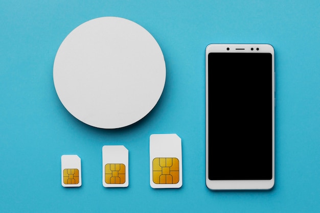 Top view of three sim cards with smartphone