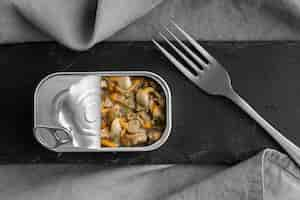 Free photo top view tin can with food and fork