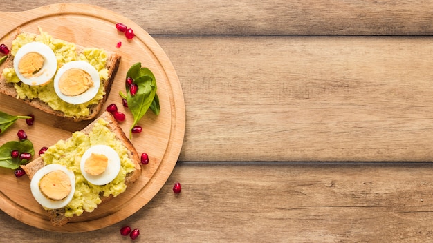 Top view of toasted bread with boiled egg on cutting board