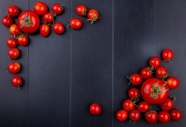 Top view of tomatoes on black surface