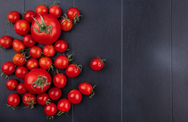 Top view of tomatoes on black surface